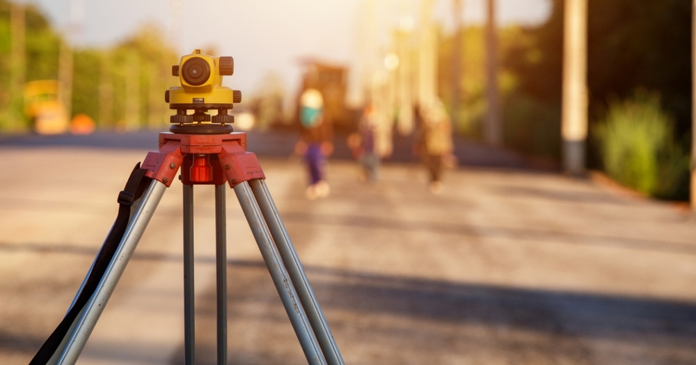 1686949971-land-survey-equipment-on-road 1686949971-land-survey-equipment-on-road